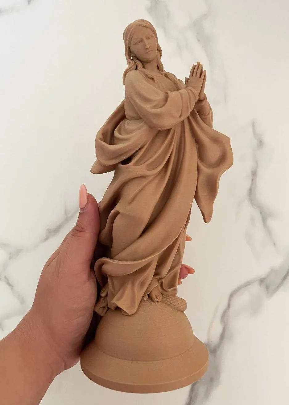 Immaculate Mary statue standing over the serpent, hands open in blessing