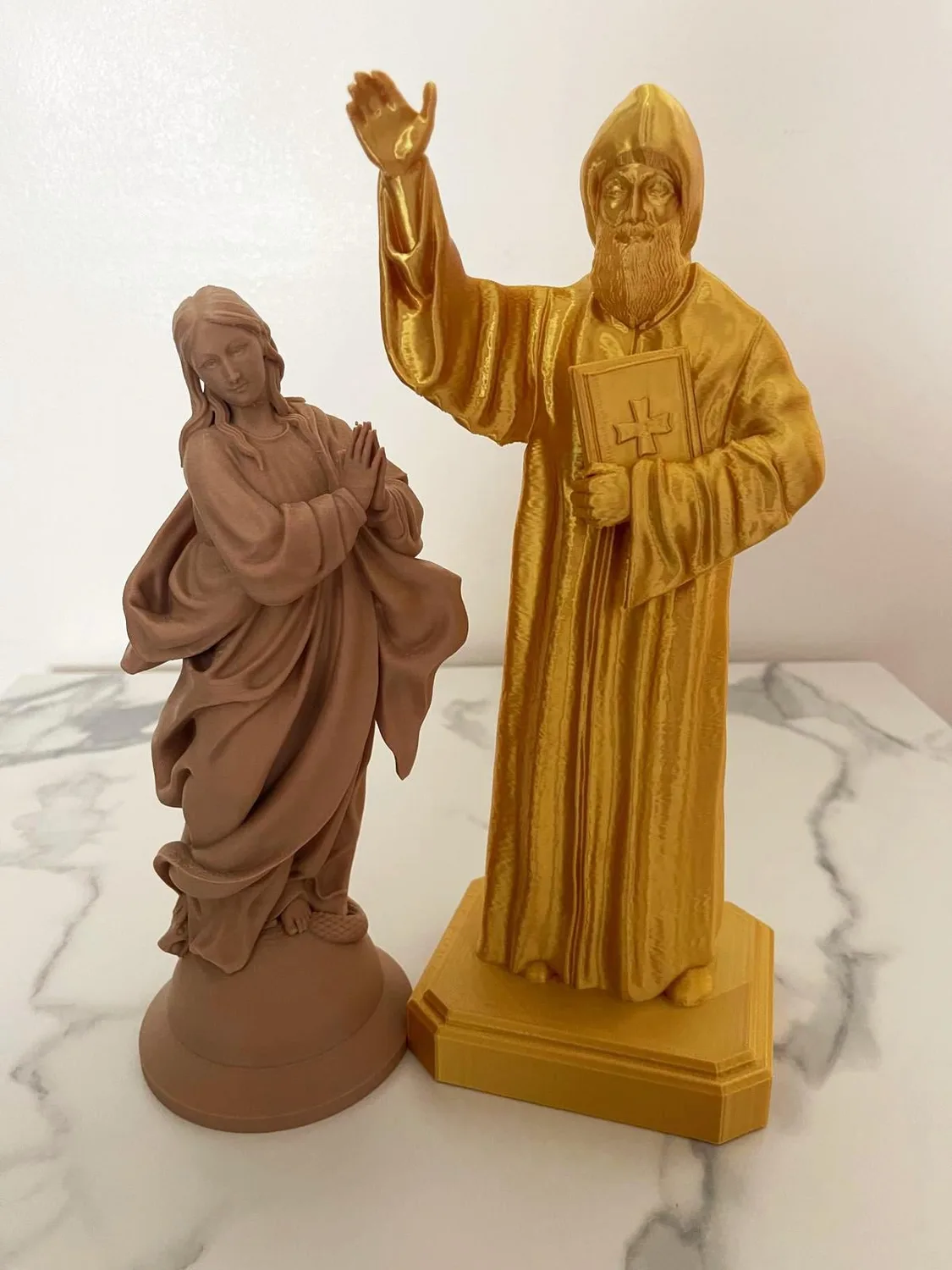 Immaculate Mary statue standing over the serpent, hands open in blessing