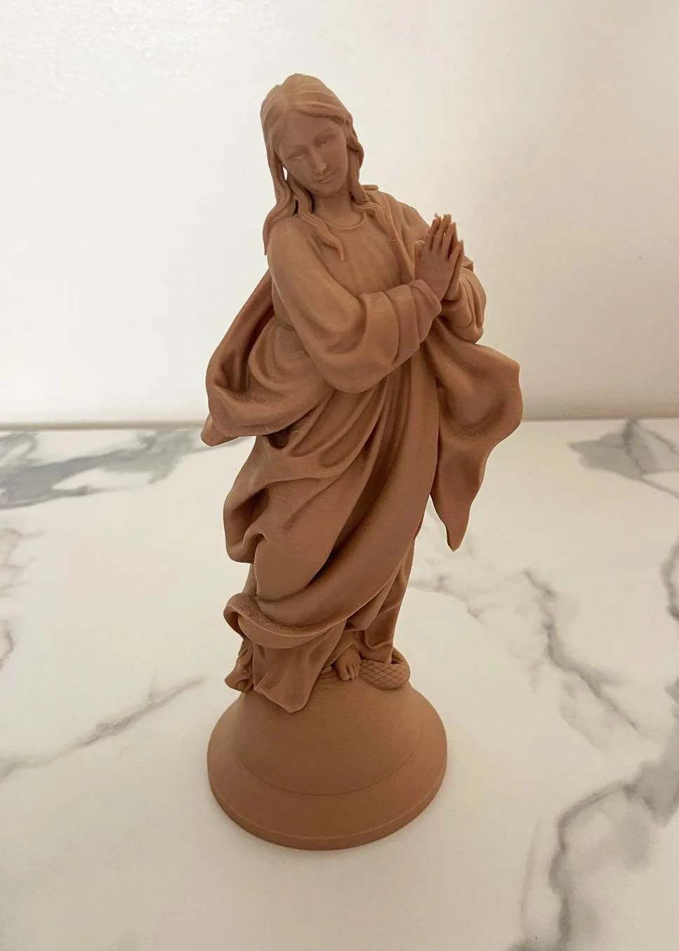 Immaculate Mary statue standing over the serpent, hands open in blessing