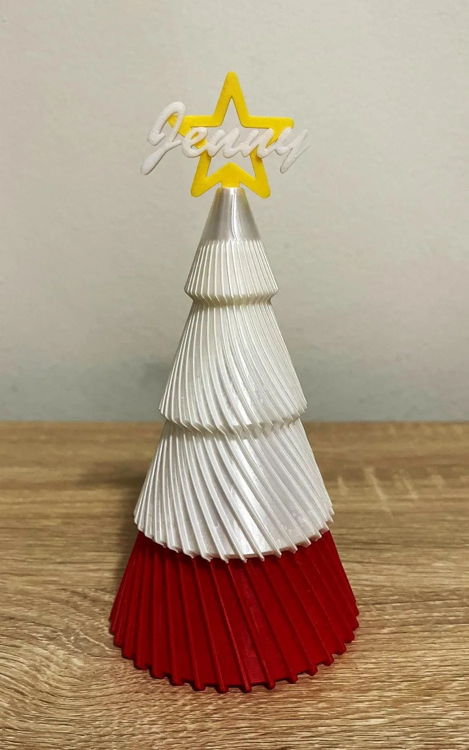 Personalised tiered Christmas trees in green and white with red bases and name stars