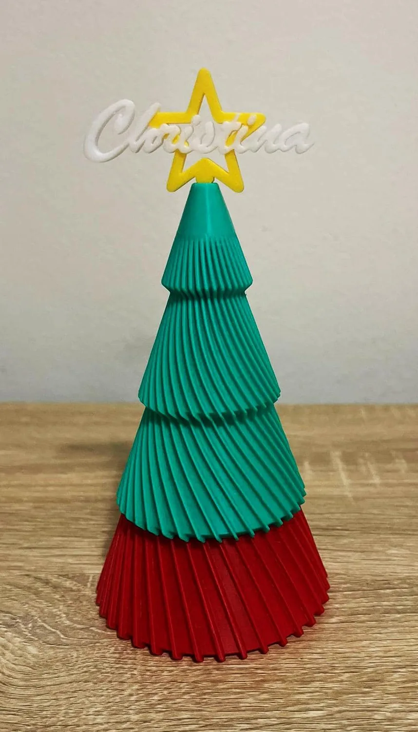 Personalised tiered Christmas trees in green and white with red bases and name stars