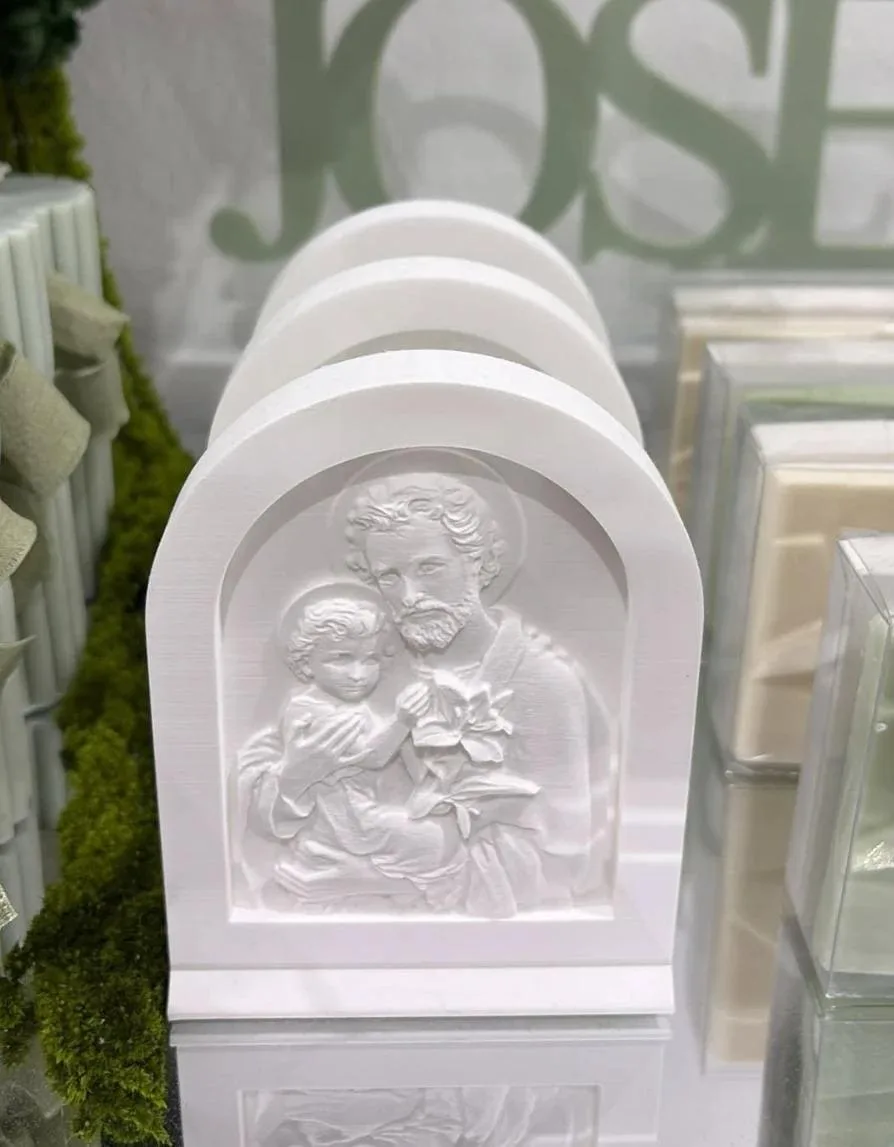 Arched icon of Saint Joseph holding the child Jesus, with a lily