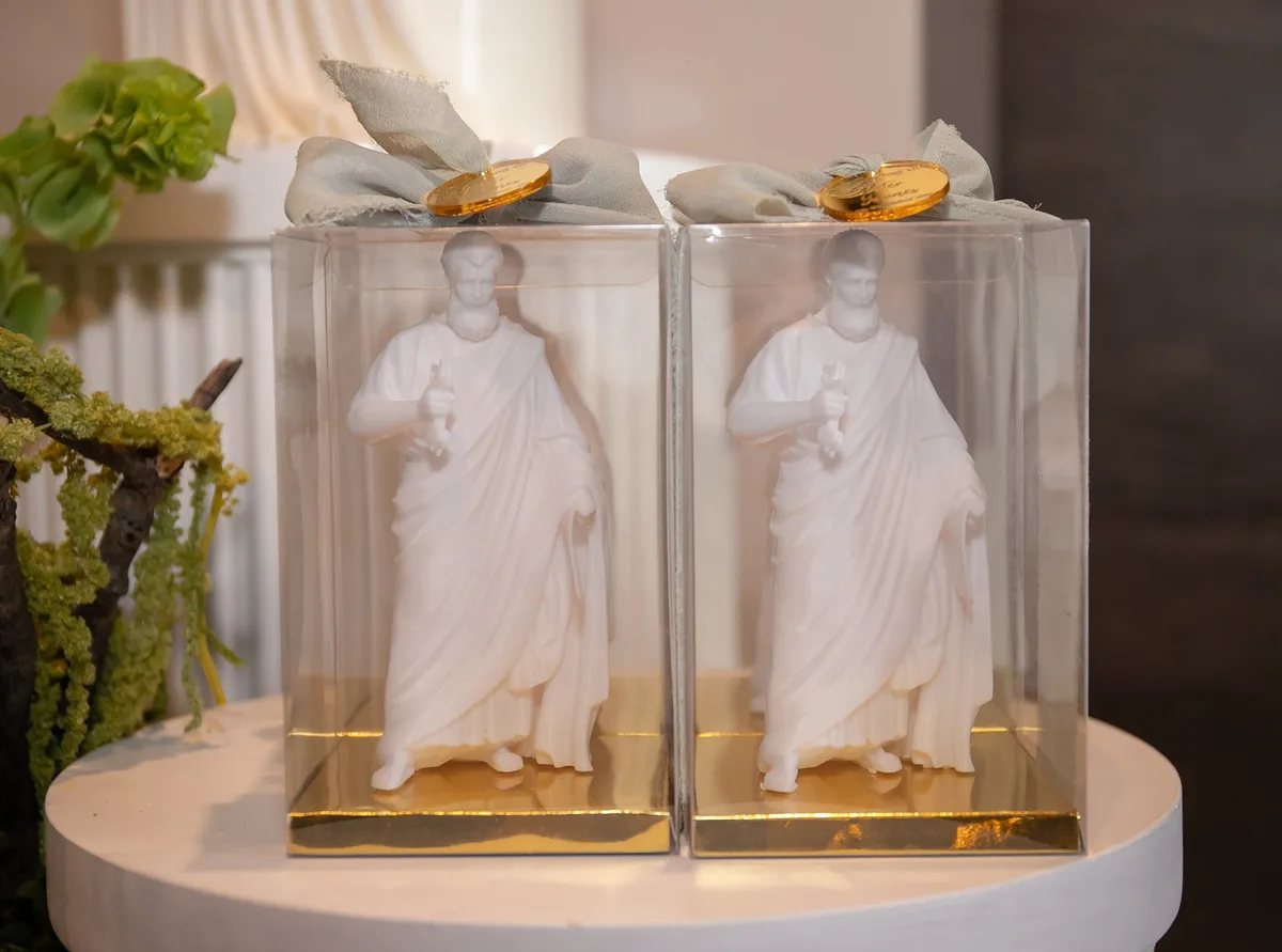 White sculptural keepsakes in clear gold-edged presentation boxes